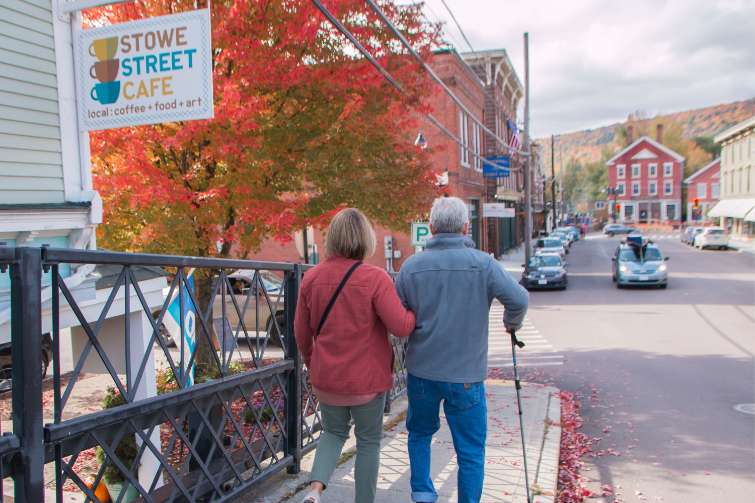 Individuals walking along Stowe Street with historic buildings nearby