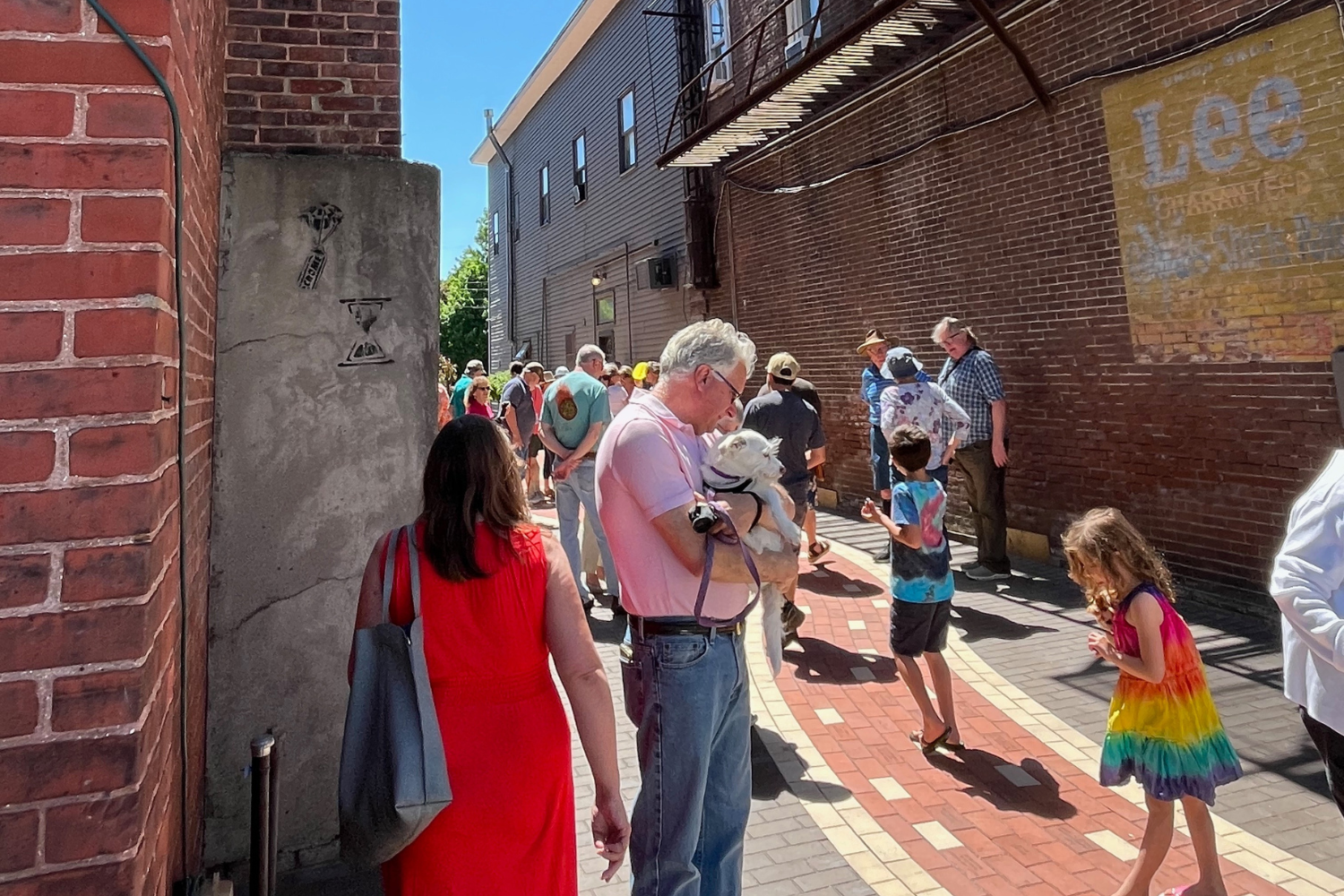 Individuals walking through in Jack's Alley in downtown Waterbury