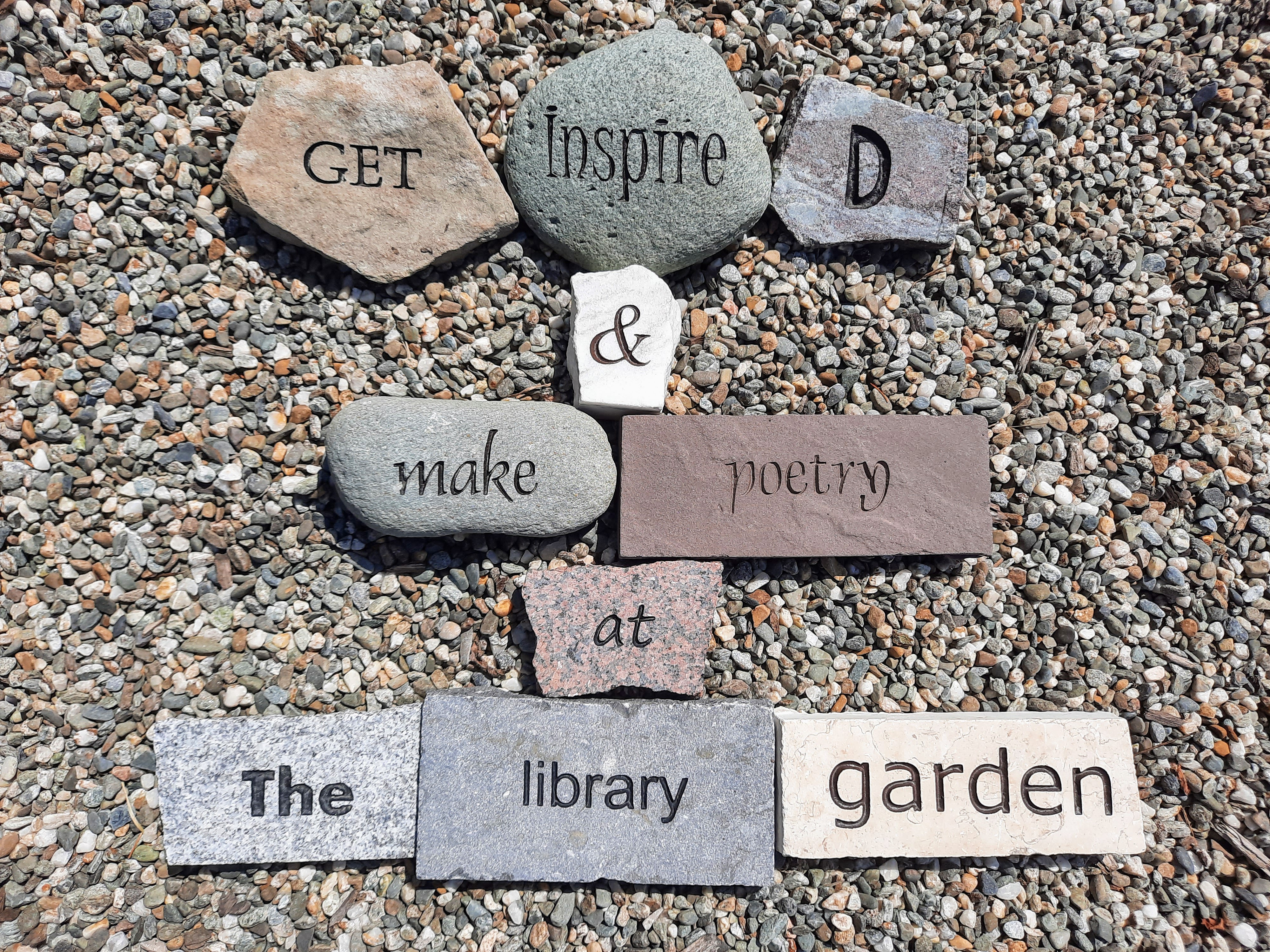 Word Rocks Saying "Get Inspired and Make Poetry at the Library Garden"