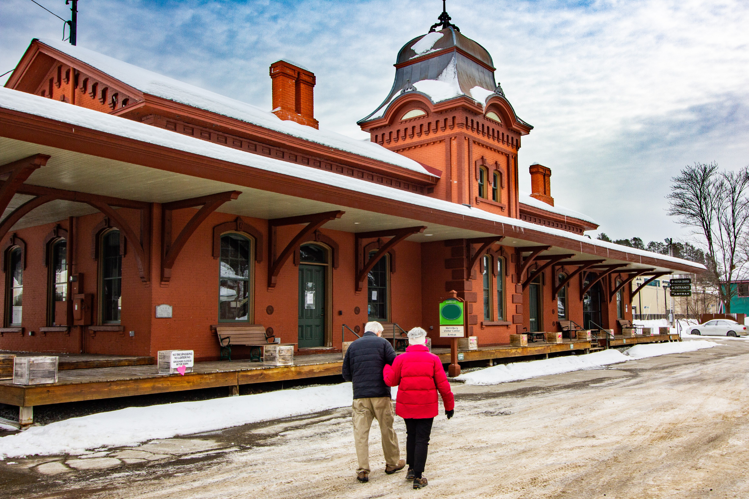 Individuals walking in front of the historic Waterbury Train Station